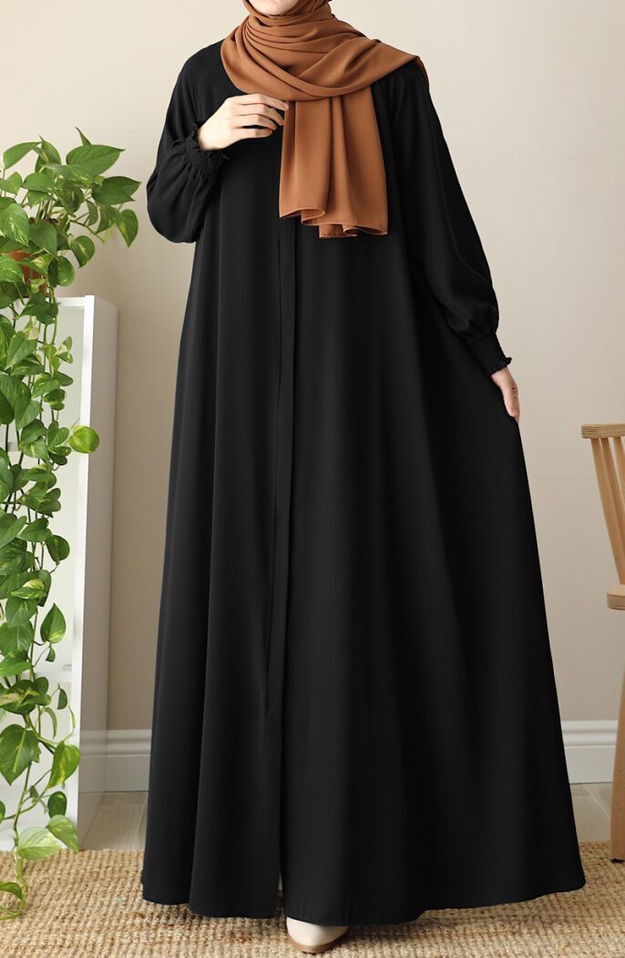 Muslim woman gracefully wearing a modest abaya with soft flow, symbolizing faith and elegance